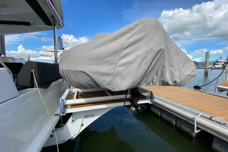  Yacht Photos Pics Covered boat on Lagoon 50 catamaran, docked at marina, under clear blue sky.