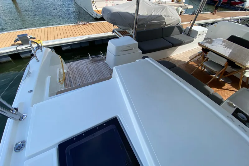  Yacht Photos Pics 2022 Lagoon 50 yacht deck with seating and dining area at marina.