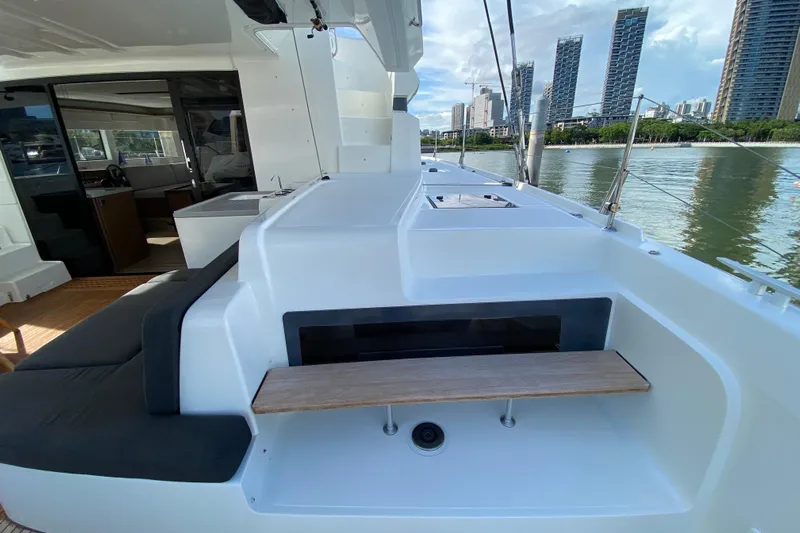  Yacht Photos Pics 2022 Lagoon 50 yacht deck with city skyline view, featuring sleek design and modern amenities.