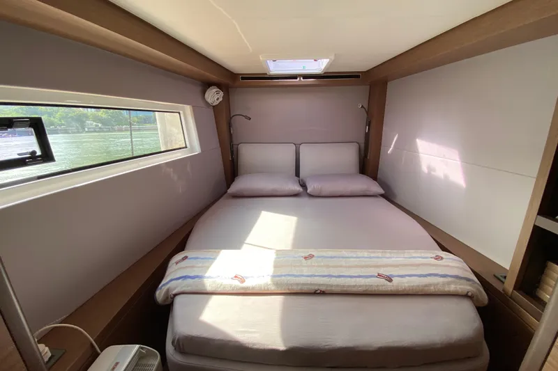  Yacht Photos Pics Luxurious bedroom interior of 2022 Lagoon 50 yacht with window view.