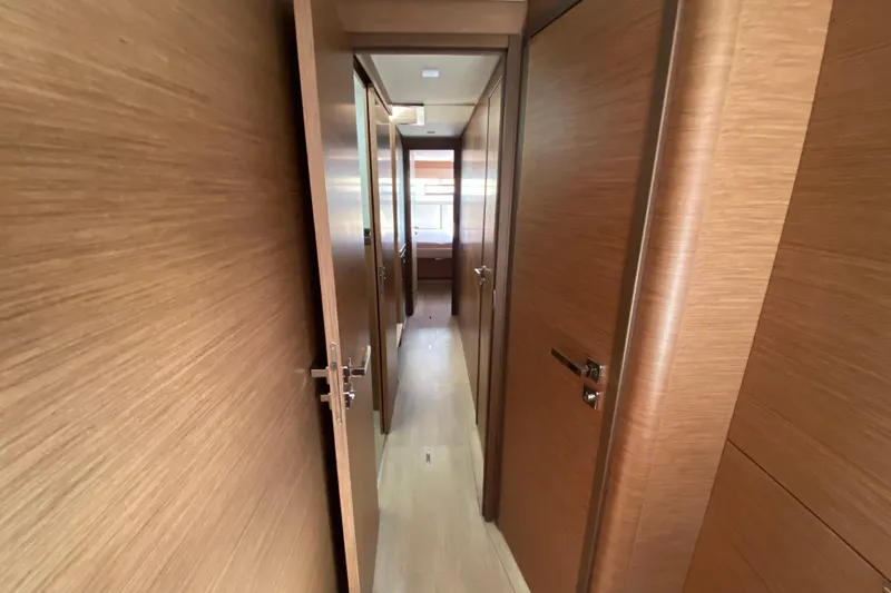  Yacht Photos Pics Interior hallway of 2022 Lagoon 50 yacht with wooden doors and flooring.