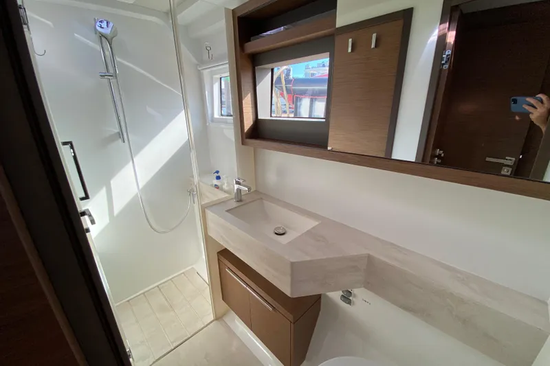  Yacht Photos Pics Modern bathroom interior on 2022 Lagoon 50 yacht, featuring sleek shower and vanity.