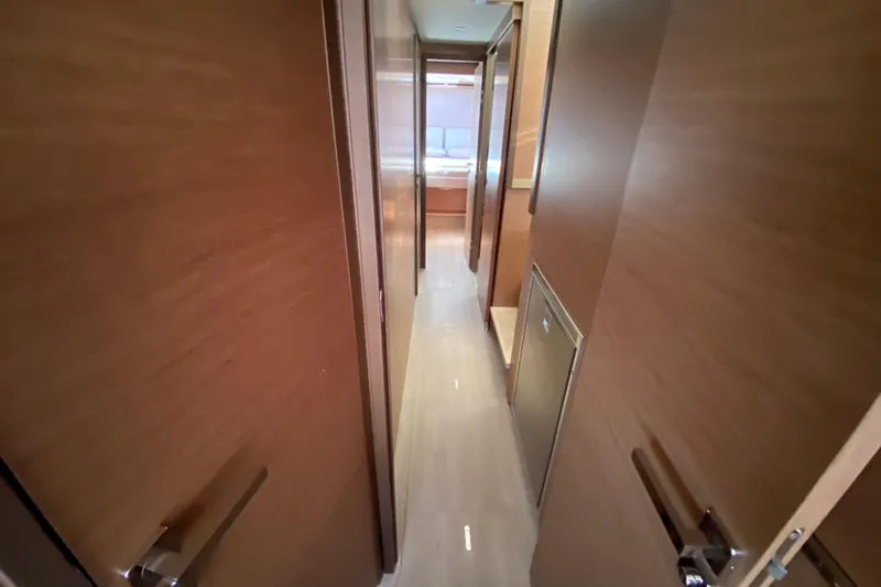  Yacht Photos Pics Interior hallway of 2022 Lagoon 50 yacht with wooden finishes.