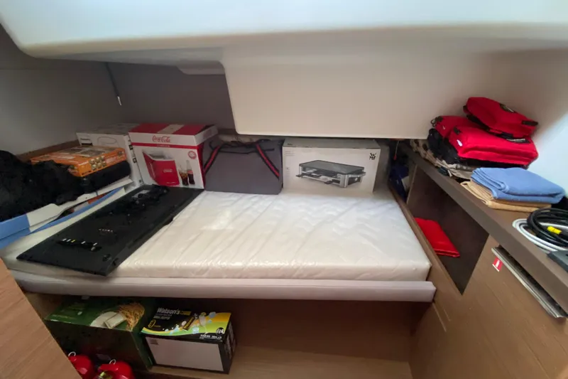  Yacht Photos Pics Storage area in a 2022 Lagoon 50 yacht with various items and supplies.