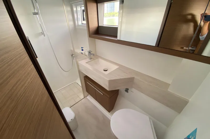  Yacht Photos Pics Modern bathroom interior on 2022 Lagoon 50 yacht, featuring sleek design and fixtures.