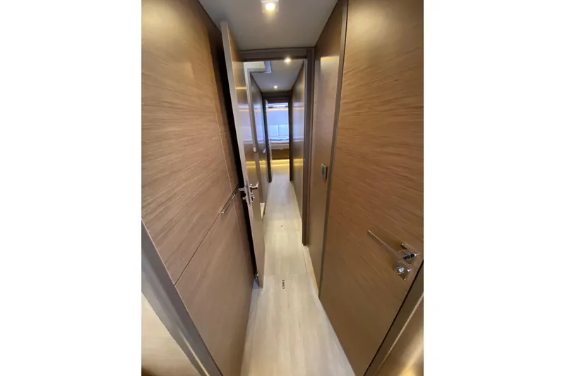  Yacht Photos Pics Interior hallway of 2022 Lagoon 50 yacht with wooden doors and modern lighting.