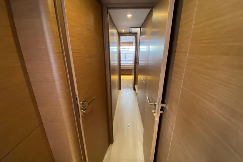  Yacht Photos Pics Interior hallway of 2022 Lagoon 50 yacht with wooden doors and modern design.