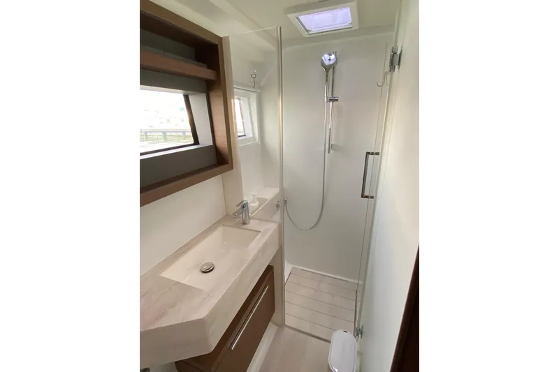  Yacht Photos Pics Modern bathroom in 2022 Lagoon 50 yacht with sleek shower and vanity.