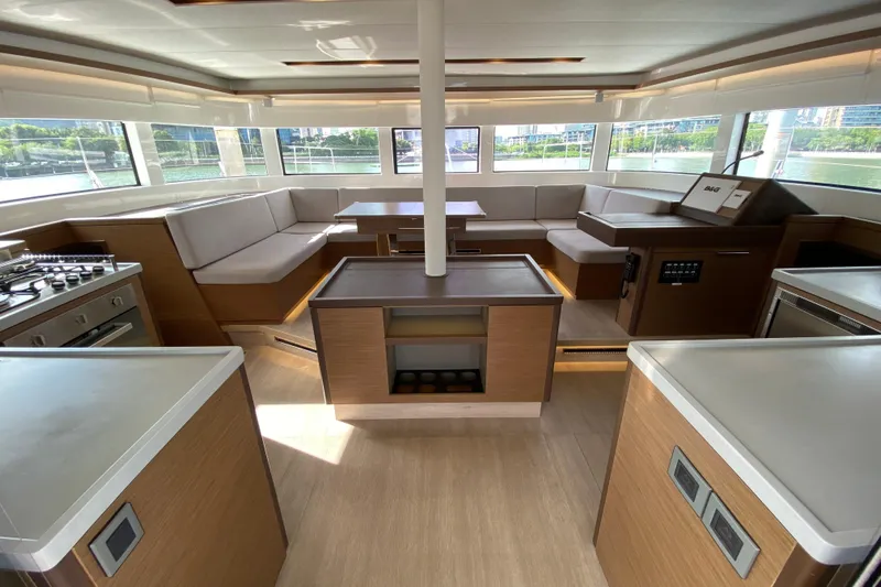  Yacht Photos Pics Luxurious interior of 2022 Lagoon 50 catamaran with modern kitchen and spacious seating area.