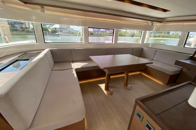 Yacht Photos Pics Luxurious interior of 2022 Lagoon 50 yacht with spacious seating and panoramic windows.