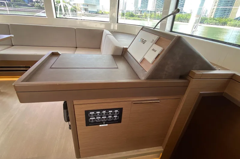  Yacht Photos Pics Interior of 2022 Lagoon 50 yacht with modern navigation station and seating area.