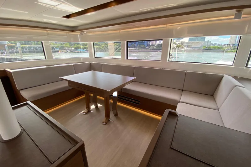  Yacht Photos Pics Luxurious interior of 2022 Lagoon 50 yacht with spacious seating and panoramic windows.
