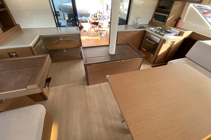  Yacht Photos Pics Interior of 2022 Lagoon 50 yacht with modern kitchen and dining area.