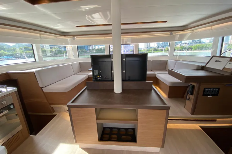  Yacht Photos Pics Luxurious interior of 2022 Lagoon 50 catamaran with modern seating and navigation equipment.