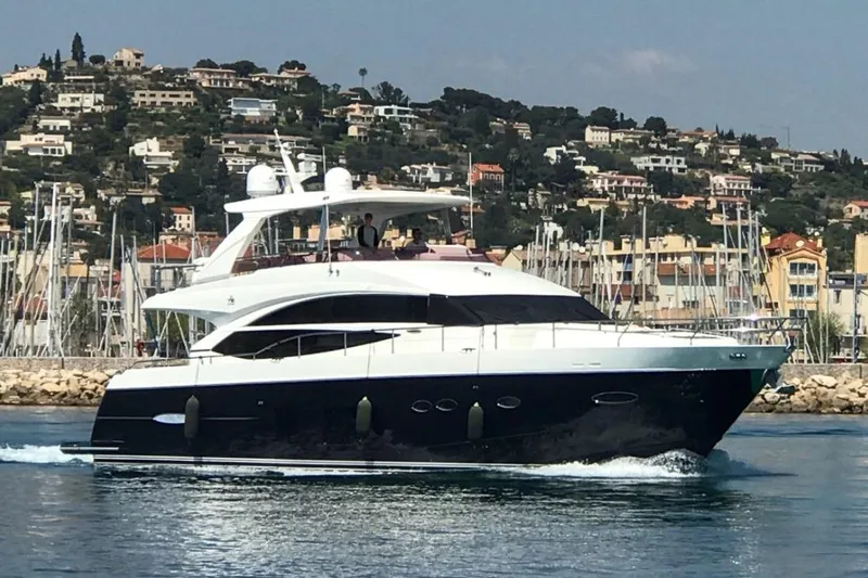  Yacht Photos Pics Luxury 2011 Princess 72 yacht cruising near scenic coastal town.