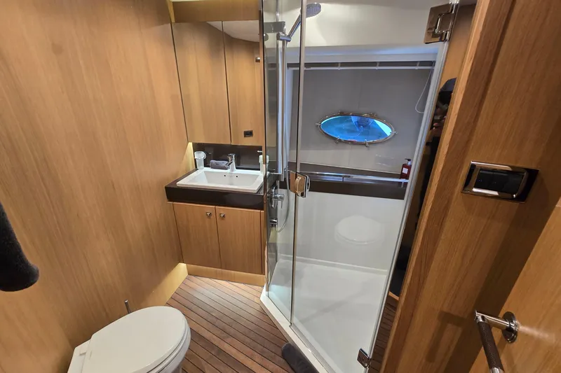  Yacht Photos Pics Luxurious bathroom on 2011 Princess 72 yacht with wood accents and glass shower.