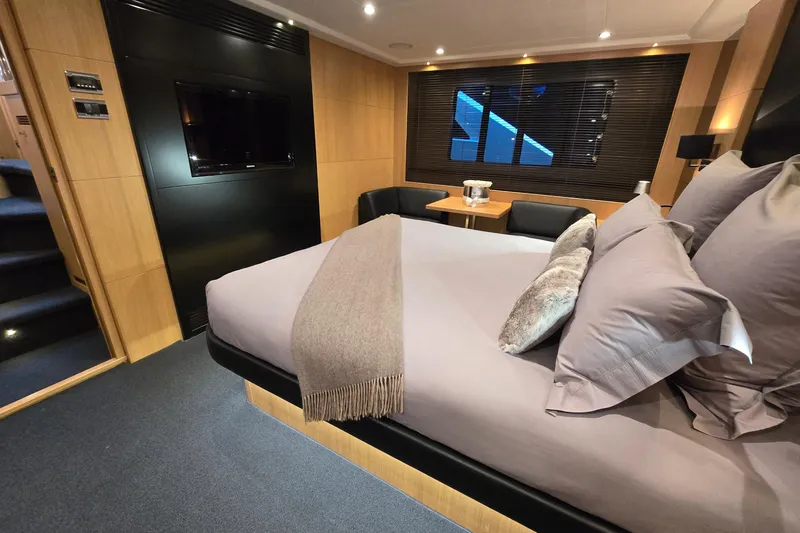  Yacht Photos Pics Luxurious bedroom interior on a 2011 Princess 72 yacht, featuring elegant decor and modern amenities.