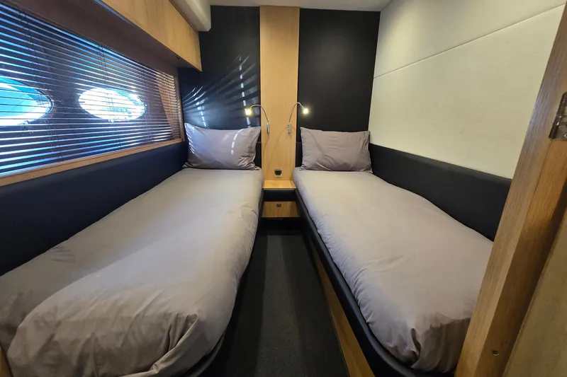  Yacht Photos Pics Twin cabin interior of 2011 Princess 72 yacht with modern design and cozy beds.