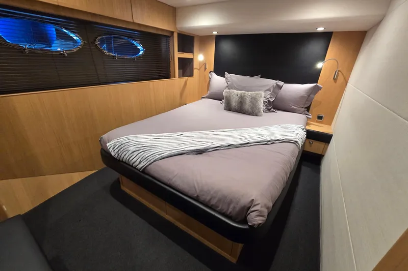  Yacht Photos Pics Luxurious bedroom interior of 2011 Princess 72 yacht with modern design and cozy bedding.