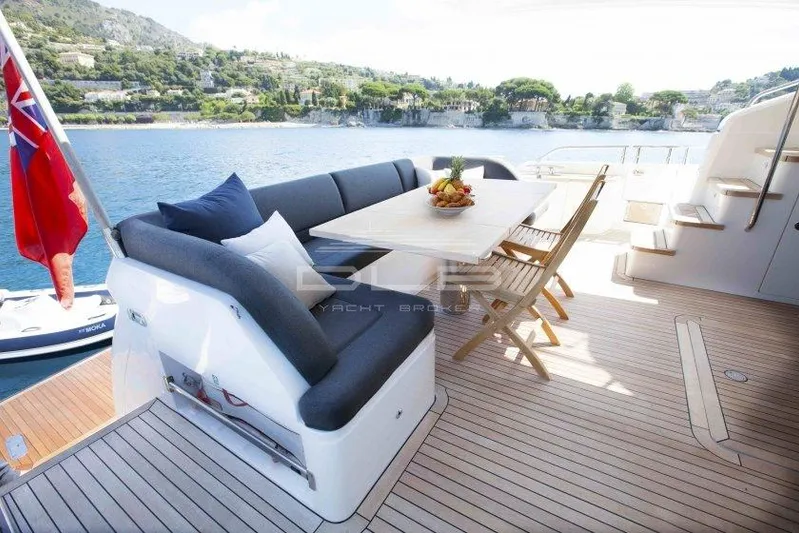  Yacht Photos Pics Luxurious 2011 Princess 72 yacht deck with seating, table, and scenic waterfront view.