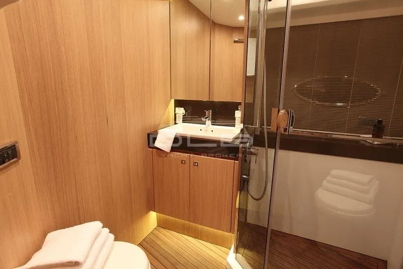  Yacht Photos Pics Luxurious bathroom interior on a 2011 Princess 72 yacht, featuring wood paneling and modern fixtures.