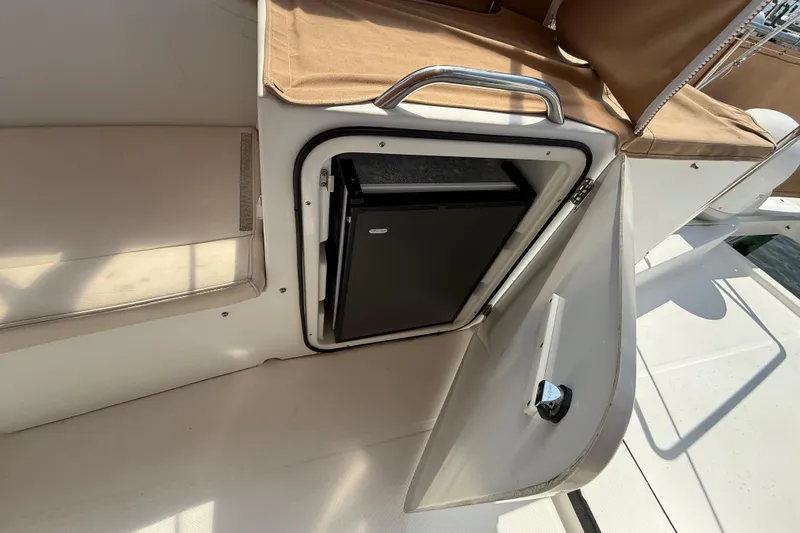 All At Sea Yacht Photos Pics 2007 Beneteau Swift Trawler 42 with open storage compartment and beige seating.