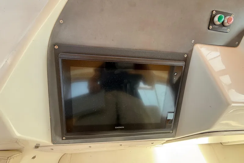 All At Sea Yacht Photos Pics Garmin display on 2007 Beneteau Swift Trawler 42 dashboard with start-stop buttons.