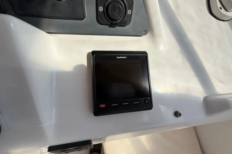 All At Sea Yacht Photos Pics Garmin display on 2007 Beneteau Swift Trawler 42 dashboard, featuring control buttons.