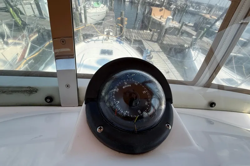 All At Sea Yacht Photos Pics Compass on 2007 Beneteau Swift Trawler 42, docked at marina with boats in background.