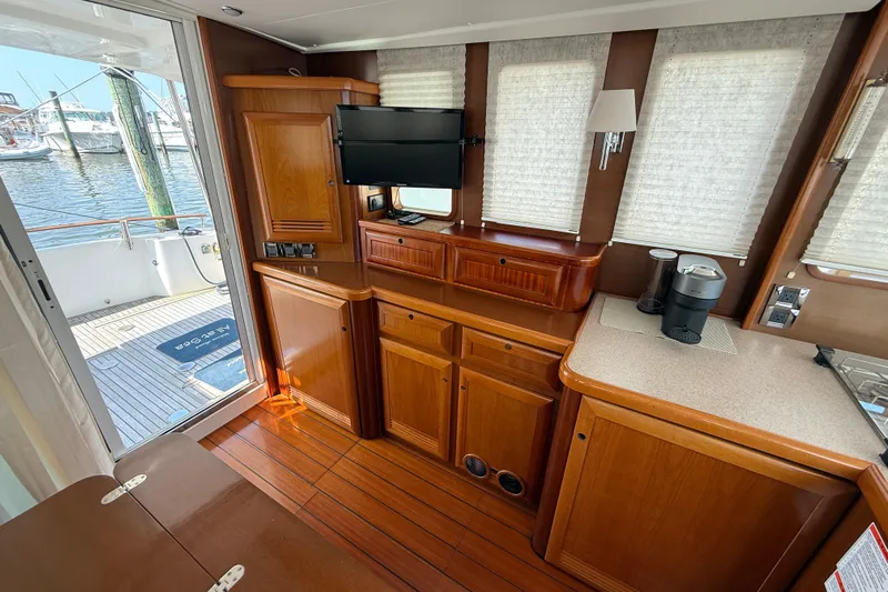 All At Sea Yacht Photos Pics Interior of 2007 Beneteau Swift Trawler 42 with wooden cabinetry and modern amenities.