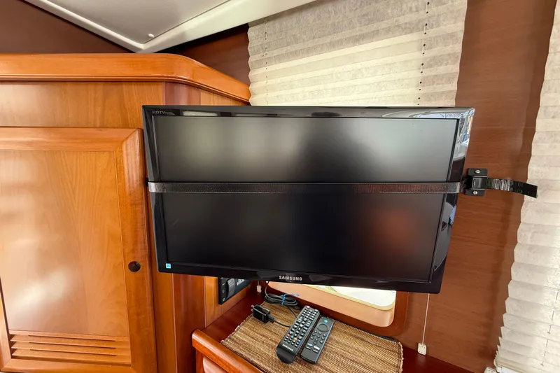 All At Sea Yacht Photos Pics Samsung HDTV mounted in 2007 Beneteau Swift Trawler 42 interior with remote controls.