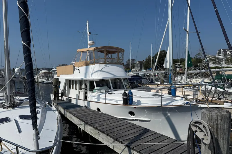All At Sea Yacht Photos Pics 2007 Beneteau Swift Trawler 42 docked at marina, surrounded by sailboats.