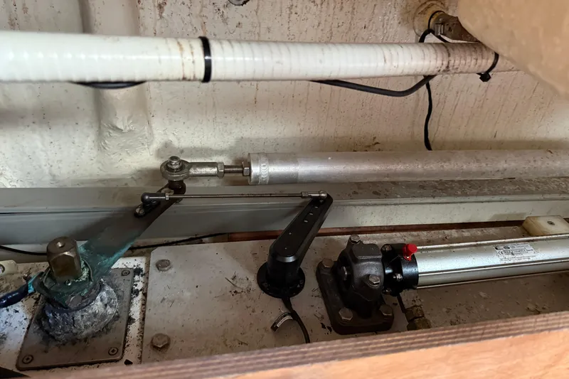 All At Sea Yacht Photos Pics Engine compartment of 2007 Beneteau Swift Trawler 42, showcasing mechanical components and piping.