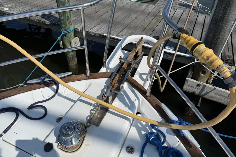 All At Sea Yacht Photos Pics 2007 Beneteau Swift Trawler 42 deck with anchor, ropes, and dock view.