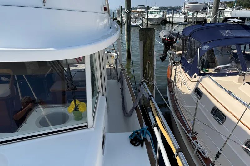 All At Sea Yacht Photos Pics 2007 Beneteau Swift Trawler 42 docked beside another boat in a marina.
