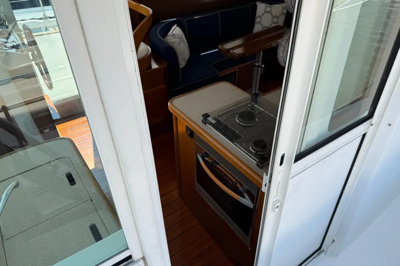 All At Sea Yacht Photos Pics Interior view of 2007 Beneteau Swift Trawler 42, featuring compact kitchen area.