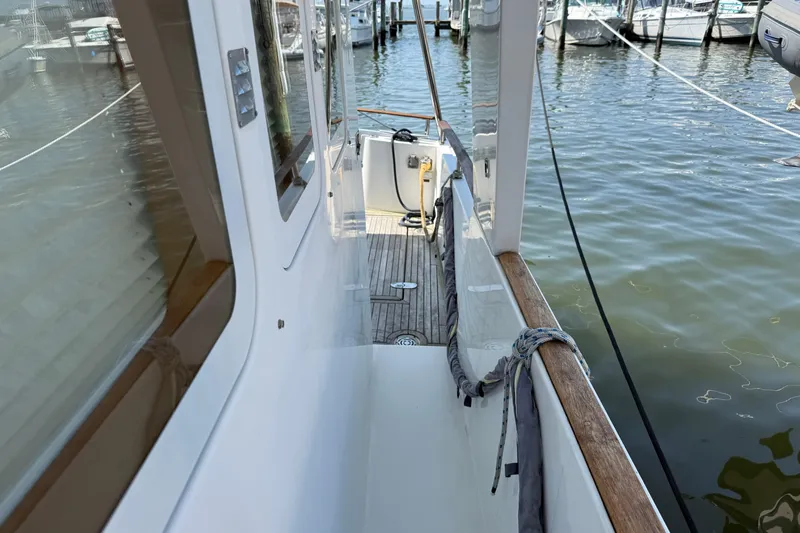 All At Sea Yacht Photos Pics 2007 Beneteau Swift Trawler 42 docked, showcasing side deck and marina view.