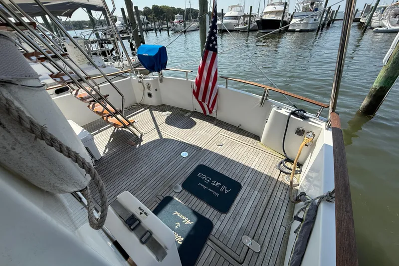 All At Sea Yacht Photos Pics 2007 Beneteau Swift Trawler 42 deck with American flag, docked at marina.