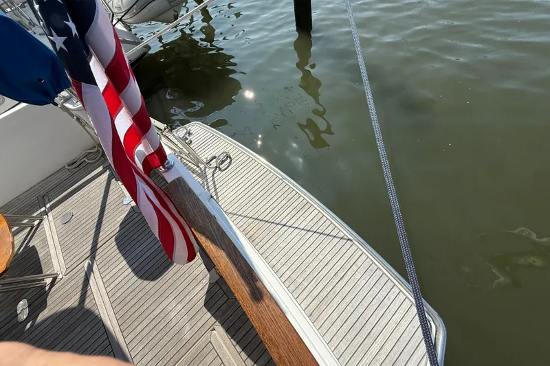 All At Sea Yacht Photos Pics Beneteau Swift Trawler 42, 2007, deck view with American flag and water reflection.