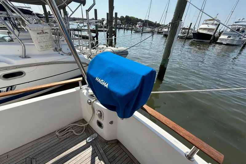 All At Sea Yacht Photos Pics Beneteau Swift Trawler 42, 2007 model, docked with Magma grill cover, marina view.