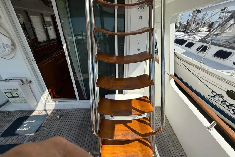 All At Sea Yacht Photos Pics Wooden steps on a 2007 Beneteau Swift Trawler 42, leading to the upper deck.