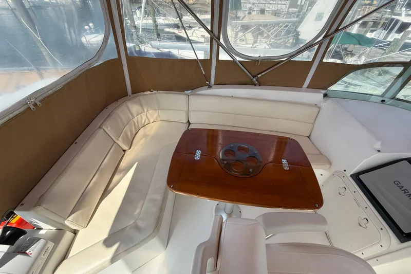 All At Sea Yacht Photos Pics 2007 Beneteau Swift Trawler 42 interior with beige seating and wooden table.