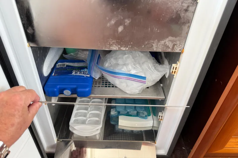 All At Sea Yacht Photos Pics Open freezer on 2007 Beneteau Swift Trawler 42, containing ice packs and trays.