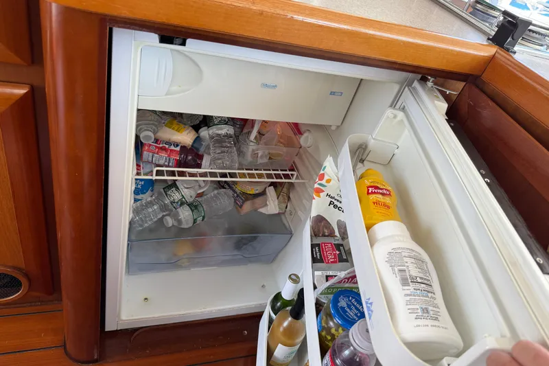 All At Sea Yacht Photos Pics Mini fridge stocked with drinks and condiments on a 2007 Beneteau Swift Trawler 42.