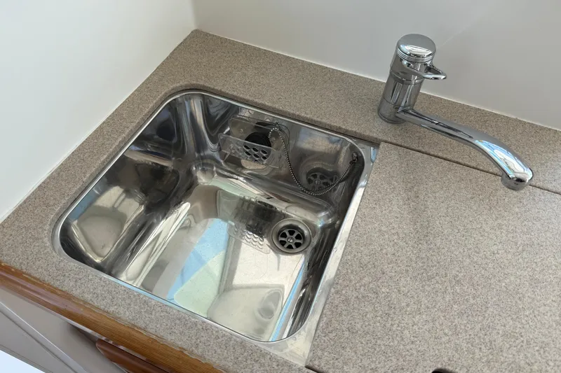 All At Sea Yacht Photos Pics Stainless steel sink and faucet in 2007 Beneteau Swift Trawler 42 kitchen area.