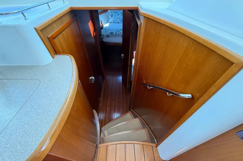 All At Sea Yacht Photos Pics Interior view of 2007 Beneteau Swift Trawler 42, featuring wooden stairs and cabin entrance.