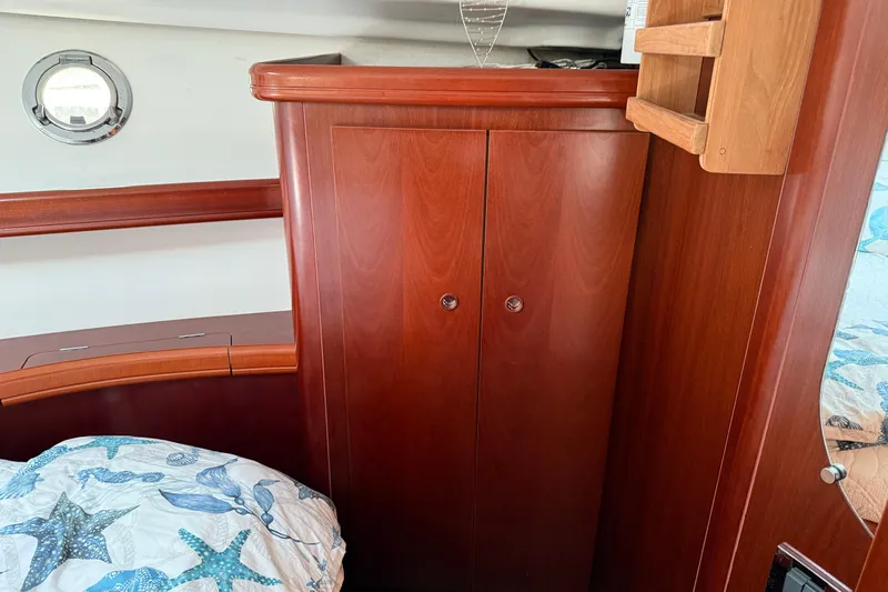 All At Sea Yacht Photos Pics Interior of 2007 Beneteau Swift Trawler 42 with wooden cabinetry and nautical decor.