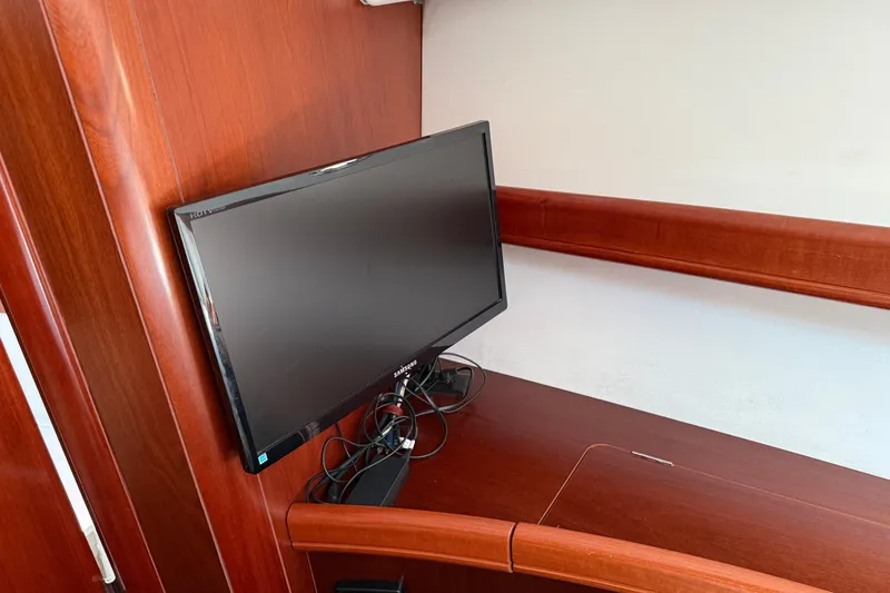 All At Sea Yacht Photos Pics Flat-screen TV on 2007 Beneteau Swift Trawler 42, mounted on wooden interior.