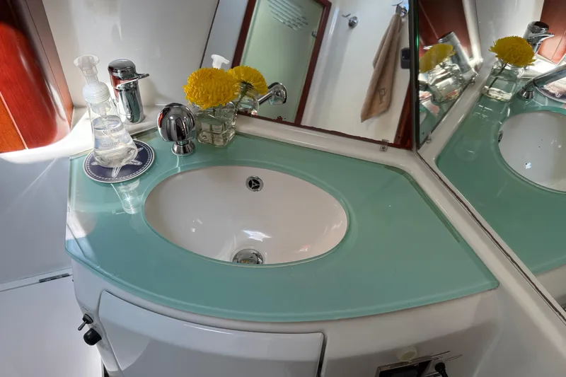 All At Sea Yacht Photos Pics Bathroom sink area on 2007 Beneteau Swift Trawler 42 with flowers and soap.