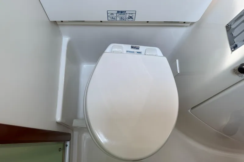 All At Sea Yacht Photos Pics 2007 Beneteau Swift Trawler 42 bathroom with white marine toilet.